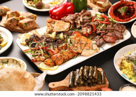 Arabic grilled arabic food dishes kebab, dolma, mansaf, shawarma
Turkish and Arabic Traditional Ramadan Mix Vali Kebab Plate inside Adana, Urfa, Chicken, Lamb, Liver and Beef on bread on table 
