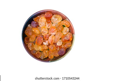 Arabic gum manna natural mana resin crystal, senegal acacia in container. Food from god heaven fall from sky. Nutritional edible aromatic health food middle east.  Top down view isolated on white.