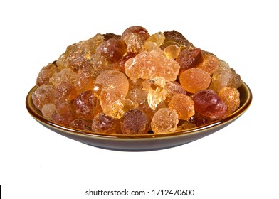 Arabic gum manna natural mana resin crystal, senegal acacia in bowl container. Food from god heaven fall from sky. Nutritional edible aromatic health food from middle east.  Isolated on white.