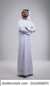 Arabic handsome man studio portraits. Businessman wearing traditional kandura from th UAE