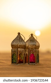 Arabic lantern placed on a desert at a sunset, good background for Eid Mubarak and Ramadan greetings
