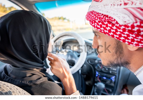 Arabic man fixing his wife
hijab