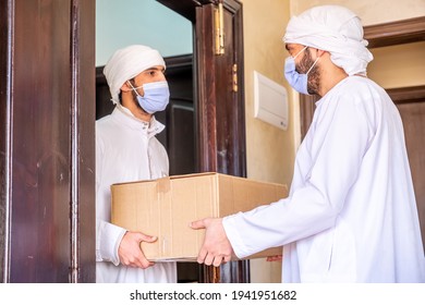 Arabic Man Holding Box Of Cartoon