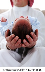 Arabic Man Holding A Newborn Baby