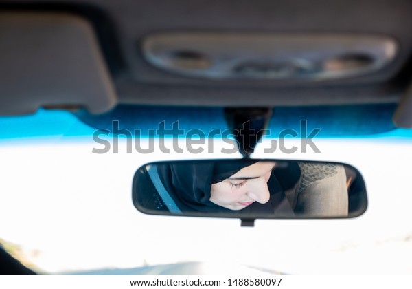 Arabic man teaching\
arabic woman driving