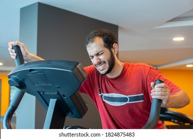 Arabic Man Training Using Cross Machine To Increase His Stamina In The Gym