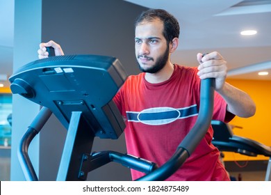 Arabic Man Training Using Cross Machine To Increase His Stamina In The Gym