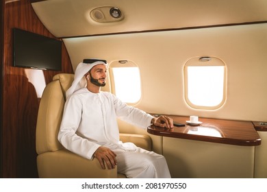 Arabic Man Wearing Kandora In Emirates Style Flying On Exclusive Private Jet - Middle-eastern Businessman With Traditional Dress Flies In Exclusive Business Class On Airplane