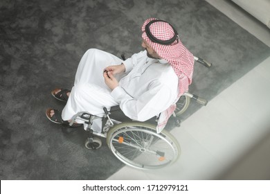 Arabic man in wheelchair at home