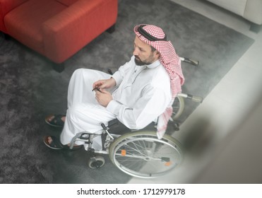 Arabic man in wheelchair at home