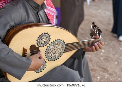 Arabic musician from Saudi Arabia plays on traditional instrument from Middle East called Oud or Ud.