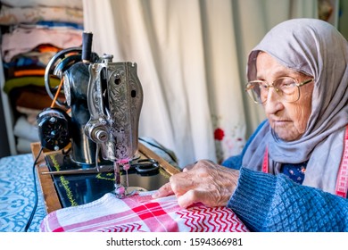 Arabic Muslim Old Woman Using Old Sewing Machine