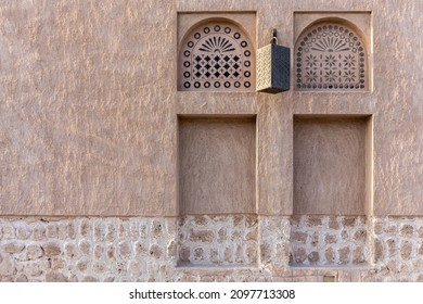 Arabic style window portals in stone wall with ornaments, traditional arabic architecture, Al Fahidi, Dubai, United Arab Emirates, copy space. - Shutterstock ID 2097713308