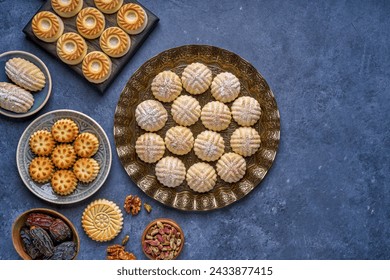 Arabic sweets. Traditional eid semolina maamoul or mamoul cookies with dates , walnuts and pistachio nuts . Top view