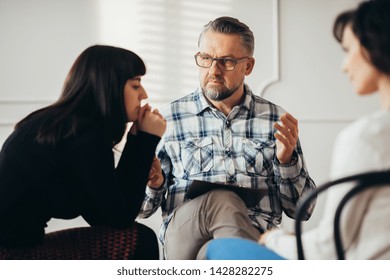 Arabic Woman Listening To Her Psychotherapist During Support Group For Abuse Survivors Meeting