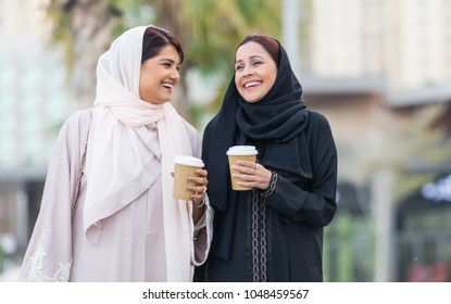Arabic women shopping outdoors in Dubai - Girls with traditional arabian dress having fun