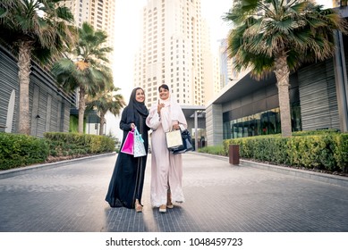 Arabic Women Shopping Outdoors In Dubai - Girls With Traditional Arabian Dress Having Fun