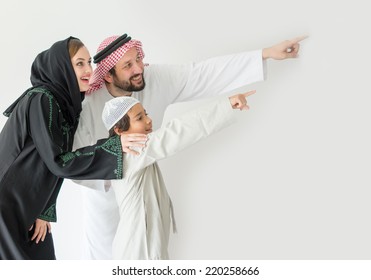 Arabic young family pointing