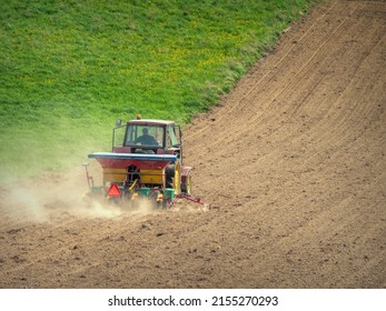 Arable Field Being Planted By Farm Tractor With Sowing Machine