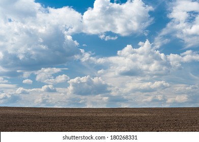 Arable land and cloudy sky