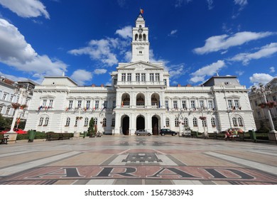 ARAD, ROMANIA - AUGUST 13, 2012: People visit the City Hall in Arad, Romania. Arad is the capital city of Arad County and 12th most populous Romanian city. It dates back to 11th century.