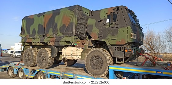 Arad,  Romania - February 12 2022: US Army Vehicle Convoy The Way To Military Maneuvers In Romania