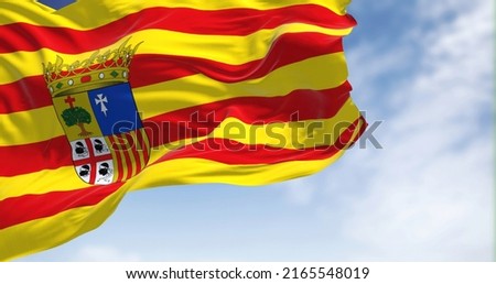 Aragonese flag waving in the wind on a clear day. Aragon is an autonomous community in Spain, coextensive with the medieval Kingdom of Aragon