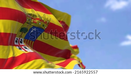 Aragonese flag waving in the wind on a clear day. Aragon is an autonomous community in Spain, coextensive with the medieval Kingdom of Aragon