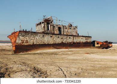 Aral sea disaster. Abandoned rotten rusty fishing boat at the desert on the place of former Aral sea