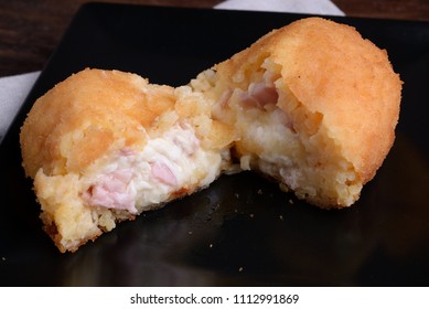 Arancina With Ham And Mozzarella On Black Plate