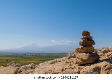 Ararat mountain vineyards with rocks cairn scenic view on the hill by Khor Virap monastery. Grape field in Ararat valley. Armenia picturesque mountain range landscape. Stock photo - Powered by Shutterstock