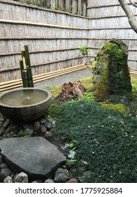 Arashiyama, Kyoto / Japan - August 2019: A Small But Neat And Tidy Japanese Zen Garden, With Water Feature, Grass, Rock And Moss