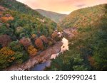 Arashiyama viewpoint, Lanscape view of mountains forest and Katsura gawa river in Arashiyama in Autumn with sunlight morning sky, Kyoto city, Japan