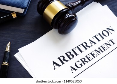 Arbitration Agreement And Gavel On A Desk.