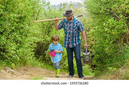 Arbor Day. Planting Trees. Tree Planting Tradition. Little Helper In Garden. Planting Flowers. Growing Plants. Boy And Father In Nature With Watering Can And Shovel. Dad Teaching Son Care Plants.