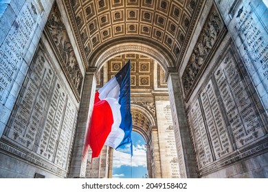 Arc de Triomphe French Flag Paris France. Completed in 1836 monument to the dead in the French Revolution and Napoleonic Wars. Includes tomb to unknown soldier