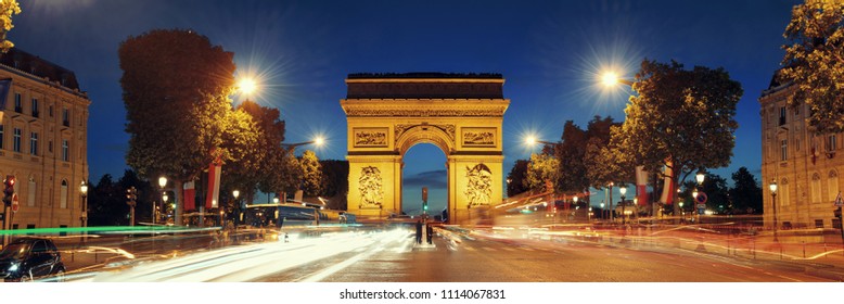 Arc de Triomphe and street view panorama at night in Paris, France.