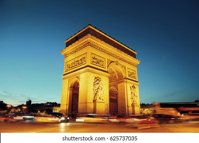 Arc de Triomphe and street view at night in Paris, France.