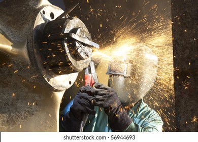 Arc Welder Working On A Tug Boat Wheel