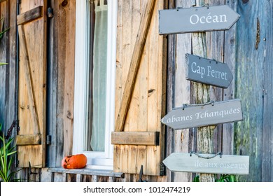 Arcachon Bay (France), decorative signboard for the ocean, the Cap Ferret, huts on stilts ('Cabanes Tchanquees') and the Island of Birds ('L'ile aux oiseaux). - Shutterstock ID 1012474219