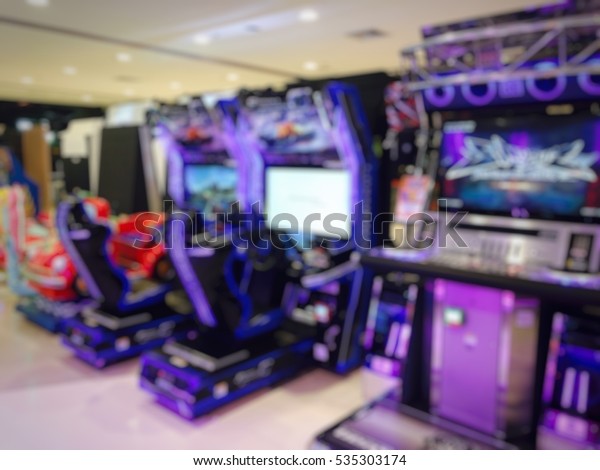 Arcade game center with car racing game\
machine blur image use for\
background