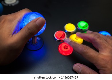 Arcade Gamer Using A Lighted Joystick And Fighter Button Layout With Neo Geo Color Scheme.