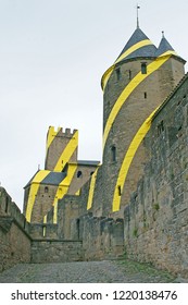 arcassonne. France - June 15th, 2018: Carcassonne with temporary yellow circles on the outside walls, artwork on the occasion of 20 years Unesco heritage in 2018