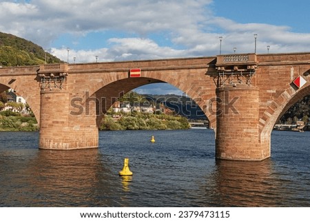 An arch of the Alte Brücke (Old Bridge) or Karl-Theodor-Brücke over the river Neckar in Heidelberg. On the left side in background the quarter Neuenheim. Baden-Württemberg, Germany