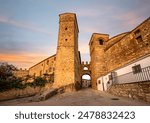 Arch between towers on Ballesteros street in Trujillo, Cáceres, Extremadura, Spain, with early morning light