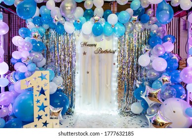 Arch blue, white and silver balloons decorate the party. Festive decorative elements, photo area. Birthday decorations with photo area, balloons, garlands and number one for a small children's party