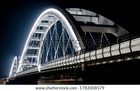 Arch Bridge by night. White bridge. Suspension bridge.