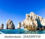 The arch in Cabo San Lucas from a boat with clear blue skies