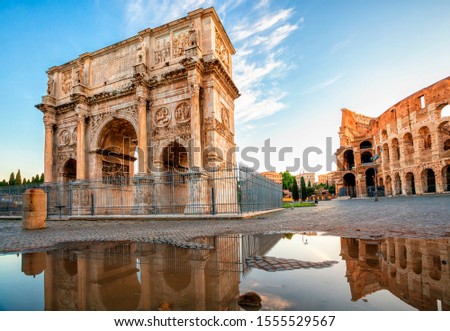 Arch of Constantine and Colosseum in Rome reflection in puddle after rain, Italy. Triumphal arch in Rome, Italy. North side, from the Colosseum. Colosseum is one of the main attractions of Rome, Italy