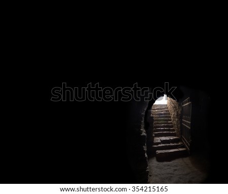 Arch fort cold dirty room iron grate rock brick trap cell wall. Gaol spooky horror shadow rise climb walk go raise up solid rusty hallway way lead upward release day sky glow light text space backdrop